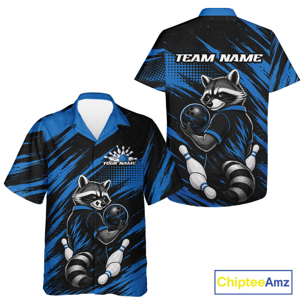 Front and back views of a short-sleeve bowling-themed button up shirt. The shirt features a raccoon bowling graphic on a blue and black brush-stroke background