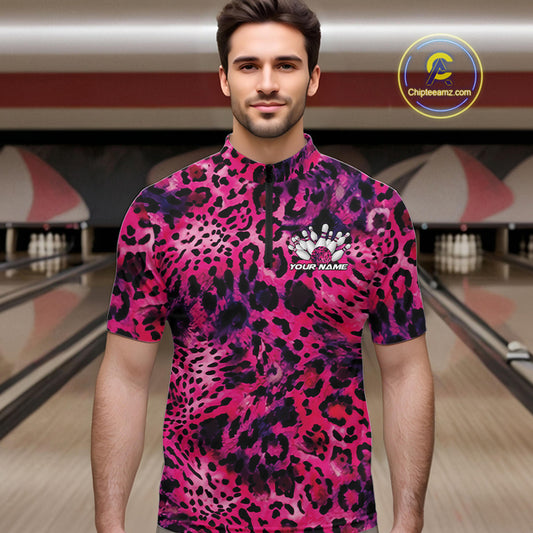 Man in a bowling alley wearing a pink, purple, and black leopard-print bowling quarter zip shirt with “Your Name” and a bowling pins graphic on the chest.