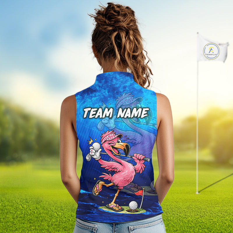 A woman viewed from behind wearing a sleeveless collared athletic top with a bright blue and purple golf-themed graphic featuring a pink flamingo, a golf ball, and the text 'TEAM NAME'. The background shows a blurred golf course with a flagstick.