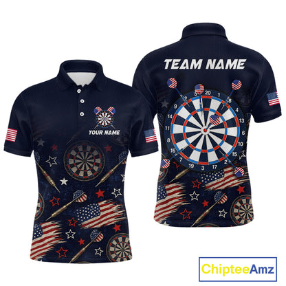 Front and back views of a navy blue short-sleeve polo shirt with a patriotic darts theme, featuring American flags, stars, darts, and a large dartboard graphic on the back. The shirt includes customizable text placeholders 'YOUR NAME' and 'TEAM NAME'.