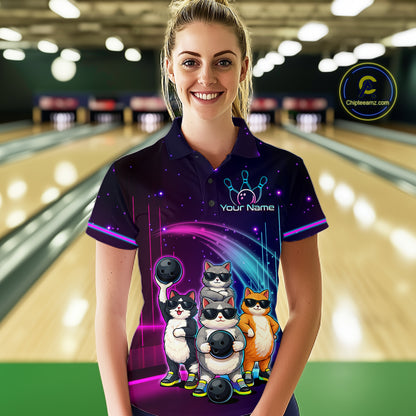 Person wearing a bowling-themed shirt with cartoon cats in a bowling alley.