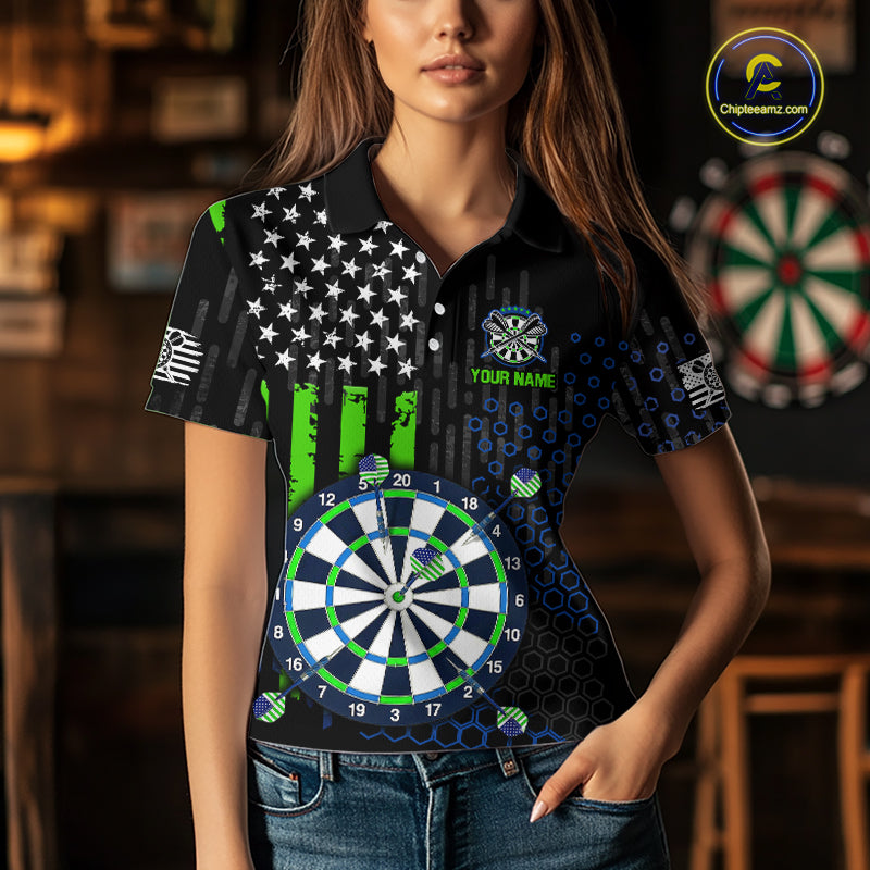 Female model wearing a custom black darts polo shirt featuring an American flag star pattern, a large dartboard graphic, and customizable 'YOUR NAME' text on the chest