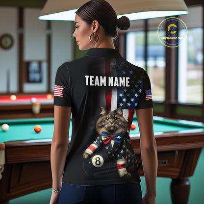 A back view of a custom black billiards polo shirt worn by a female model turned away from the camera in front of a pool table. The shirt features a large distressed US flag pattern on the back, with a large white 'TEAM NAME' text placeholder. The cat and 8-ball motif is at the bottom of the flag design. The background is a billiards room with a table and hanging lights.