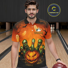 Load image into Gallery viewer, Man wearing a Halloween-themed polo shirt with a pumpkin and zombie design in a bowling alley.