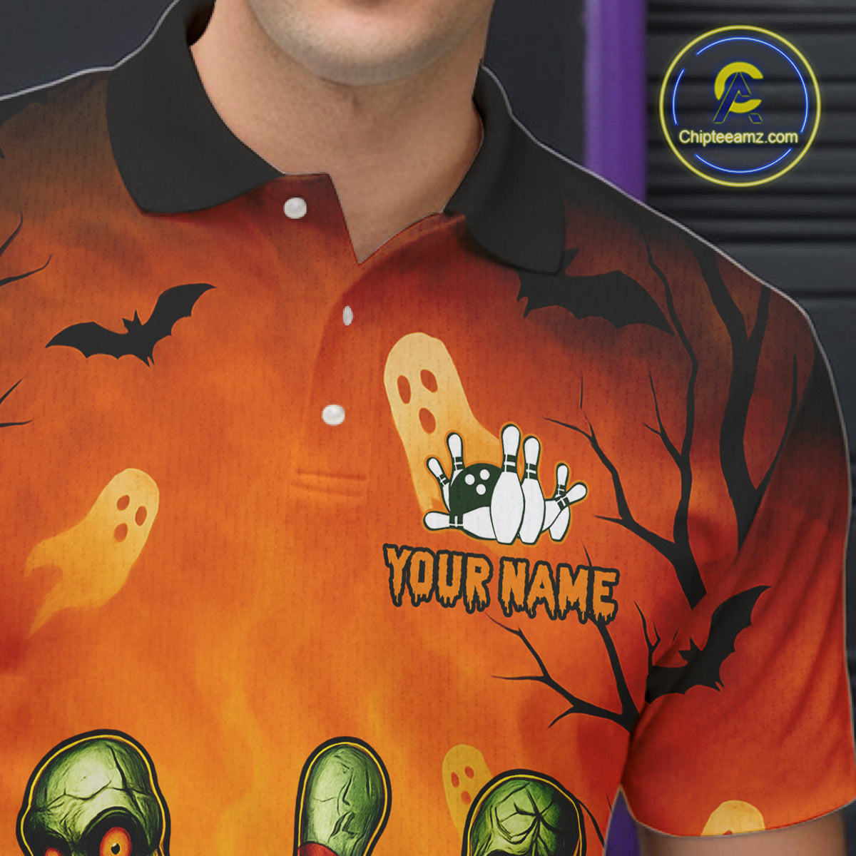 Orange Halloween-themed polo shirt with ghost, bat, and zombie design on a person wearing it.