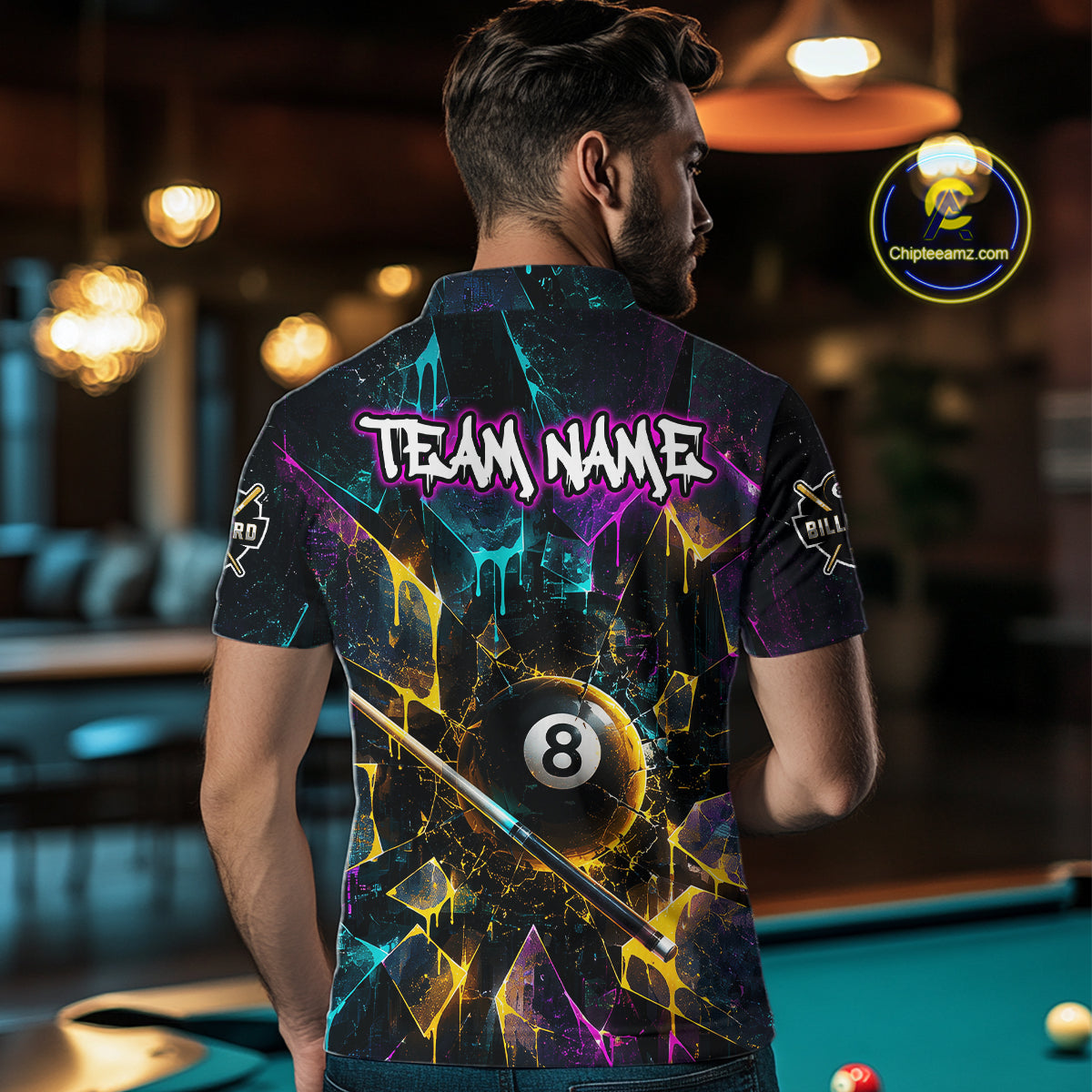 Back view of man wearing custom colorful shattered glass 8 ball billiard polo shirt in a billiard room showing personalized team name