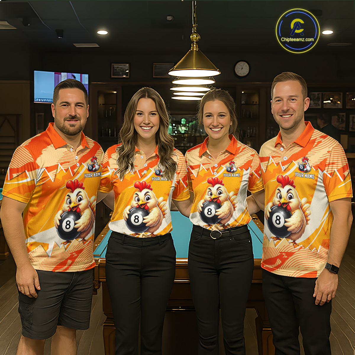 Four people wearing matching orange and yellow shirts with a chicken and pool ball design in a bar setting.