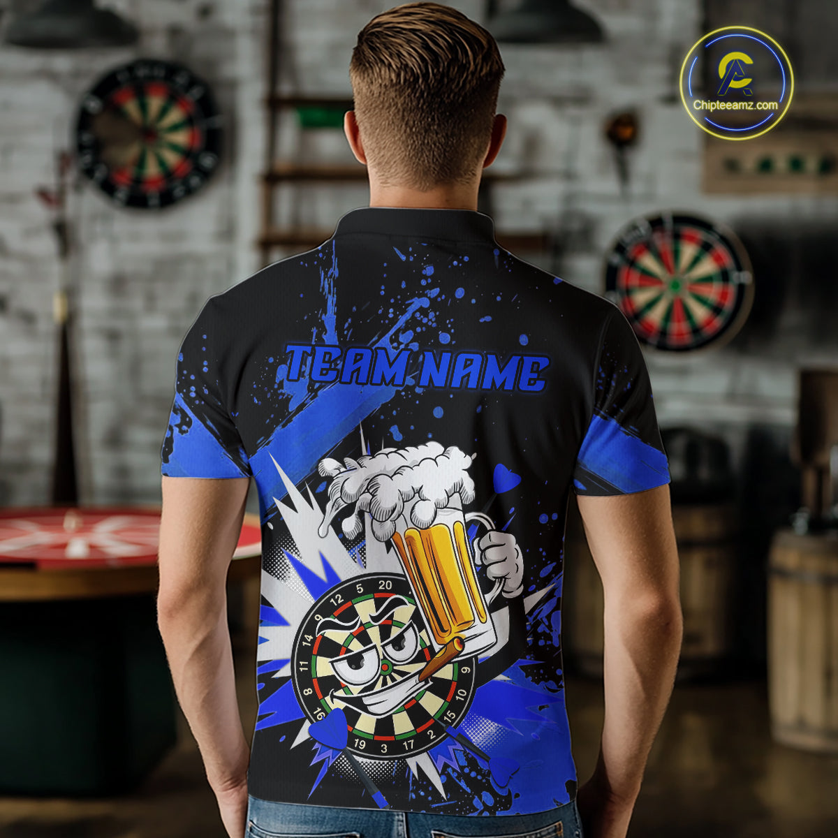 A man viewed from behind wearing a black and blue short-sleeve polo shirt with a beer-themed graphic on the back, featuring a cartoon beer mug, foam burst, dartboard, and the text 'TEAM.NAME'.