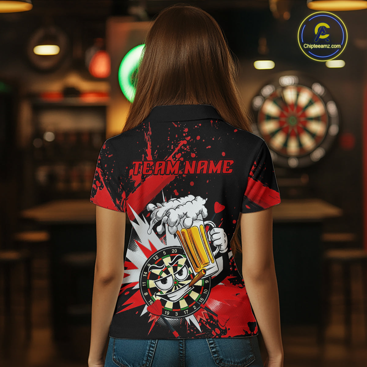A woman viewed from behind wearing a black short-sleeve polo shirt with a red and white graphic print on the back. The design features the text 'TEAM NAME' above a cartoon hand holding a foaming beer mug with a dartboard motif.