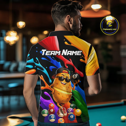 Person wearing a colorful shirt with a potato character and billiard balls design, standing in a pool hall.