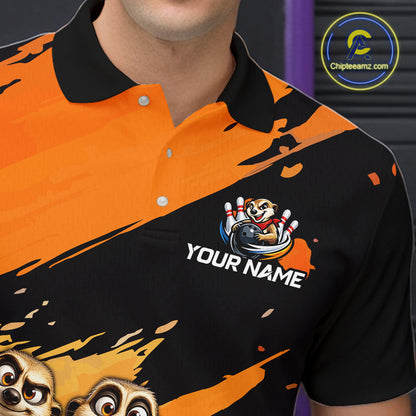 A close-up of a person wearing a short-sleeve polo shirt with a bold orange and black graphic design, featuring cartoon animal faces and a custom name patch that reads 'YOUR NAME'.