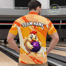 Load image into Gallery viewer, Person wearing a bowling shirt with a chicken holding a bowling ball design in a bowling alley.