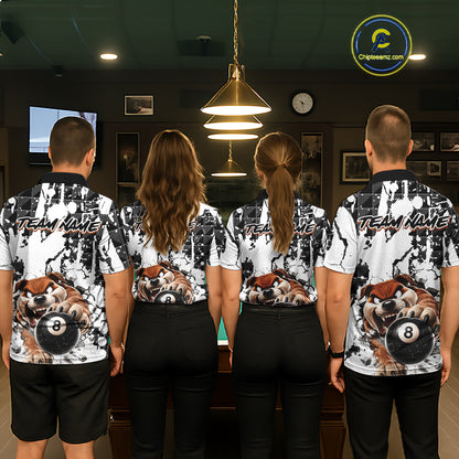 Four people wearing matching shirts with a bear and pool ball design in a room.