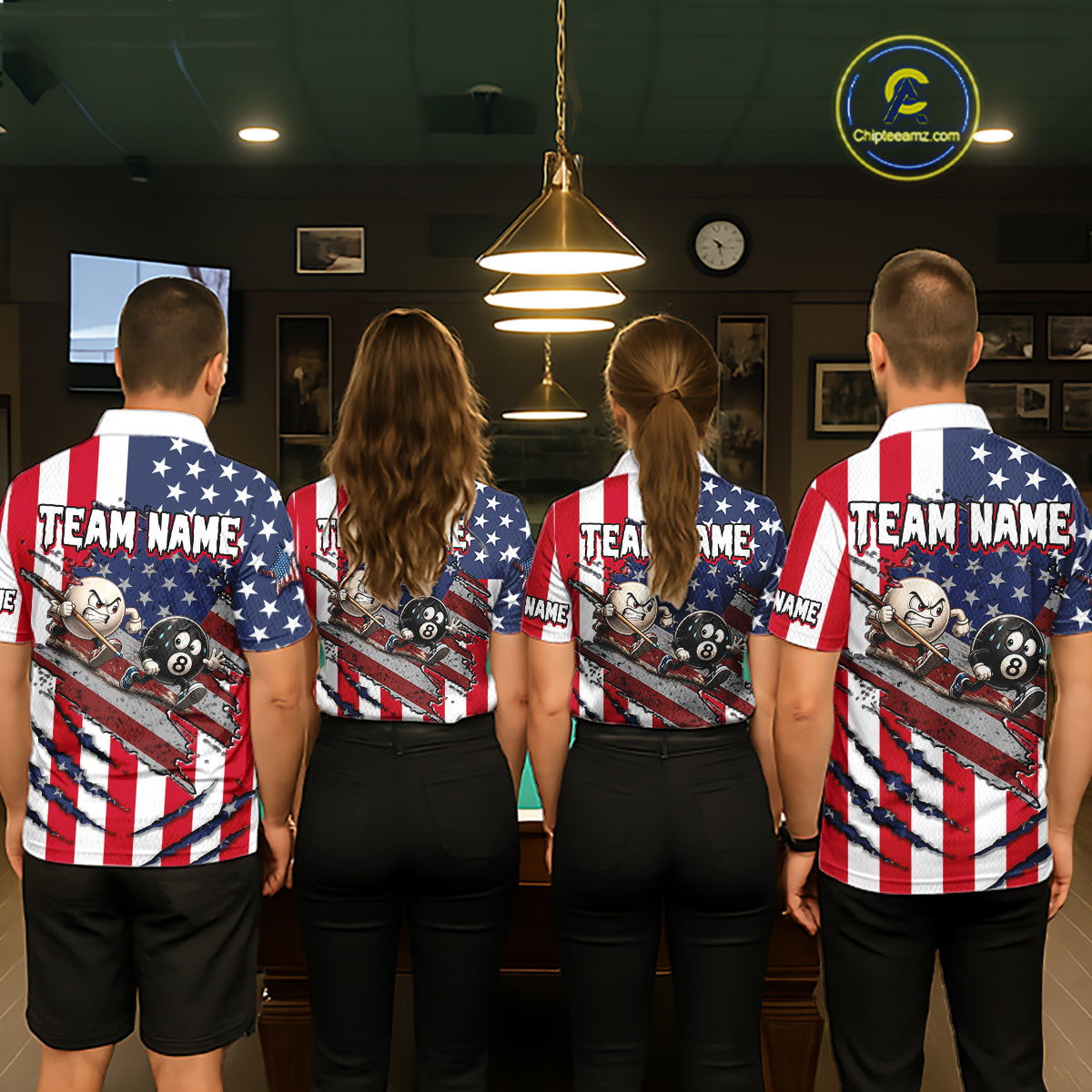 Four people standing with their backs to the camera in a dimly lit indoor room, wearing matching patriotic American flag-themed jerseys with 'TEAM NAME' printed across the back. The jerseys feature red and white stripes, white stars on a blue field, and a graphic of pool balls and a cue stick.
