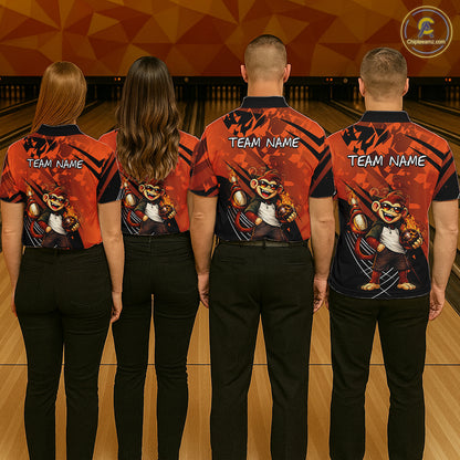 Four people standing with their backs to the camera in a bowling alley, wearing matching custom bowling shirts with a cartoon monkey graphic and 'TEAM NAME' text. The shirts are orange and black with black patterns.