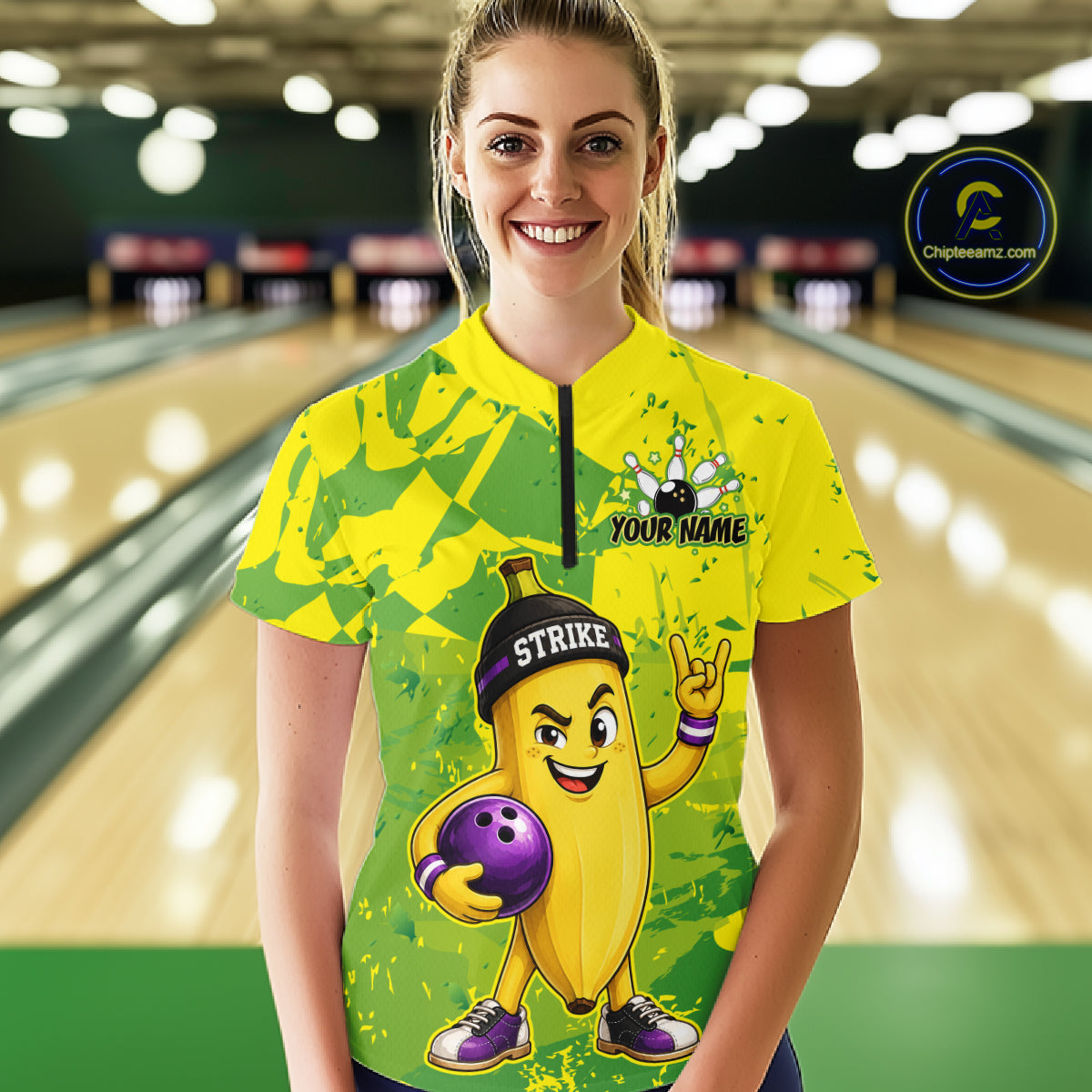 A woman wearing custom yellow banana bowling quarter-zip shirt front view featuring a funny cartoon fruit and bowling ball, displaying Your Name, at the bowling alley