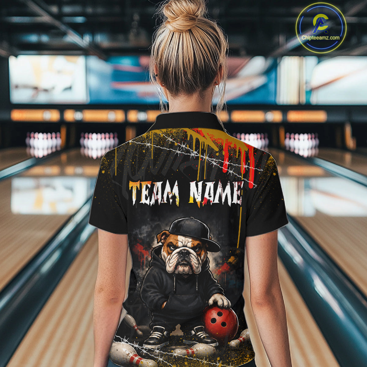 A man wearing custom black bulldog bowling polo shirt back view featuring a bowling ball, paint drip effect and grunge pattern, displaying Team Name, at the bowling alley
