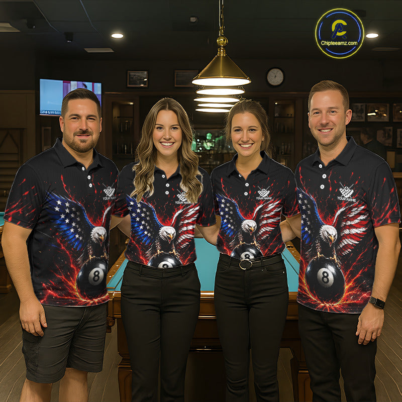 Four people wearing matching bowling shirts with an eagle and ball design in a bowling alley.