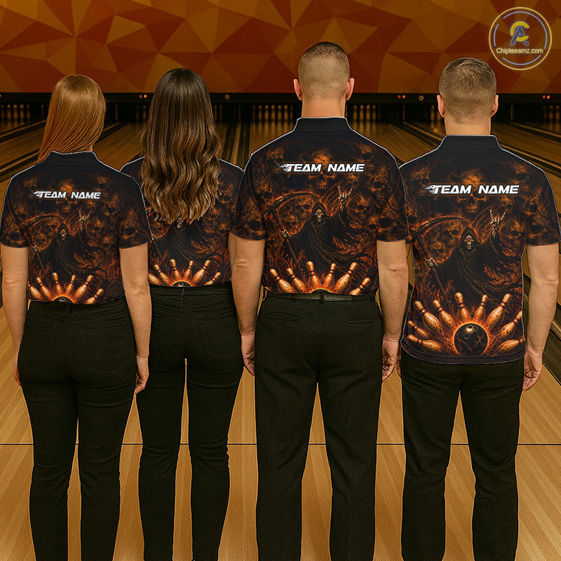 Four people standing with their backs to the camera in a bowling alley, wearing matching dark navy bowling shirts with a fiery orange and gold bowling pin graphic on the back and white 'TEAM NAME' text. 