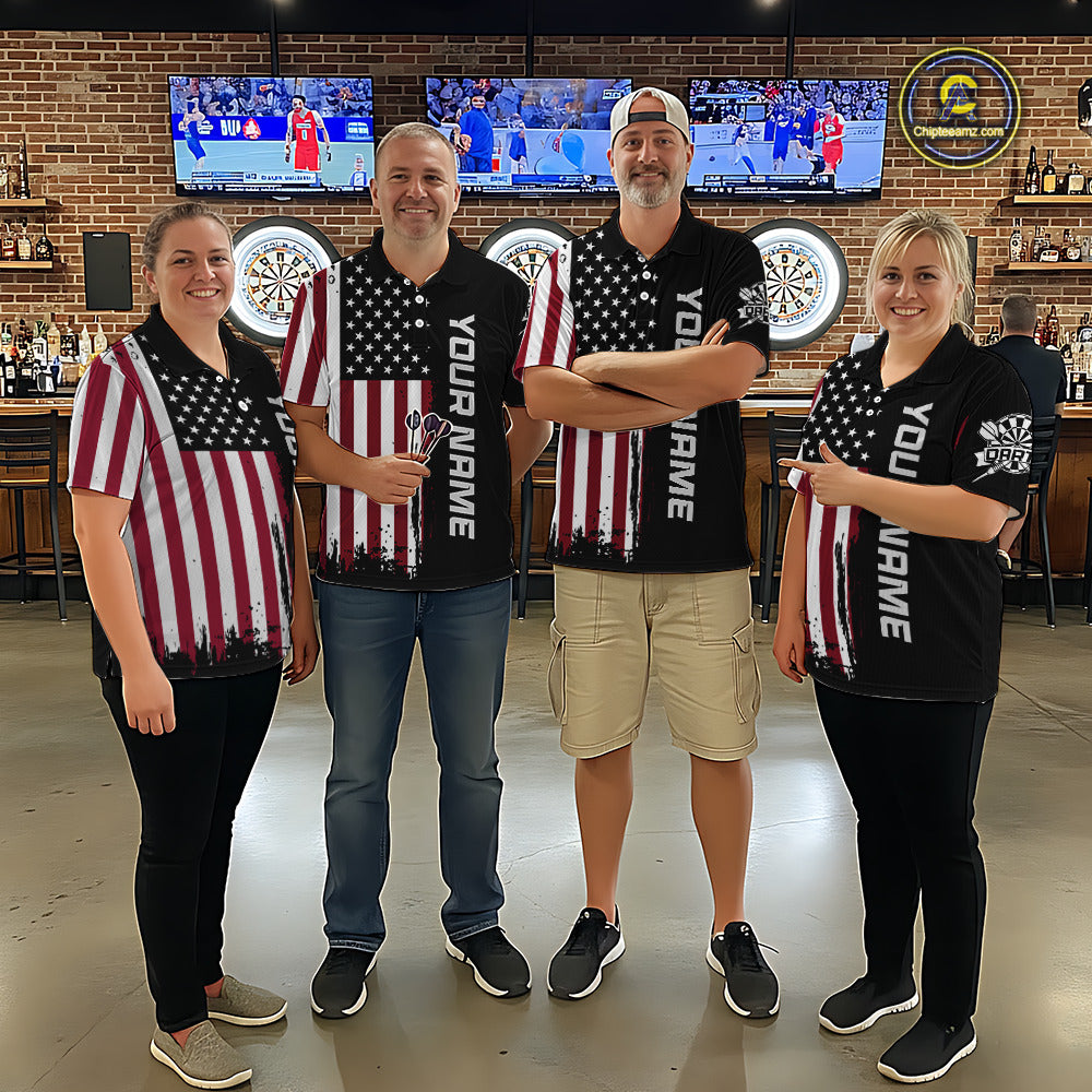 Group of four wearing matching custom patriotic dart polo shirts featuring distressed American flag graphics in a professional dart room.