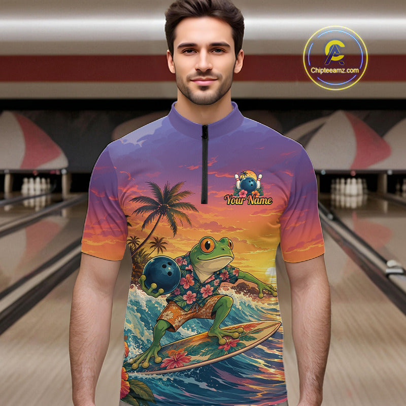 A man wearing a short-sleeve quarter-zip bowling shirt with a colorful graphic of a frog surfing on a wave under a sunset sky. The shirt has a purple-to-orange gradient background with a palm tree and the text 'Your Name' on the chest.