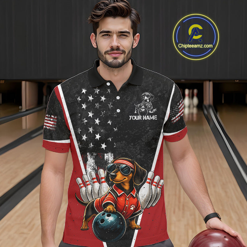 A man wearing custom black red patriotic bowling polo shirt front view featuring a fierce cartoon dog, bowling ball and American flag, displaying Your Name, at the bowling alley
