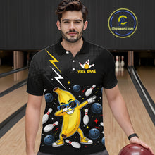 Load image into Gallery viewer, Man wearing a black polo with a banana character and bowling design in a bowling alley.