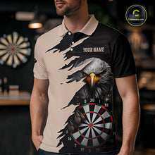 Load image into Gallery viewer, Person wearing a beige and black darts polo featuring a bald eagle, torn-flag graphics, dartboard designs, and custom team text.