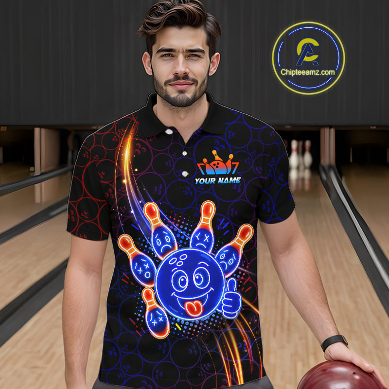 Man standing in a bowling alley wearing a black neon-style bowling polo shirt with a glowing blue cartoon bowling ball mascot, fiery orange pin graphics, and custom name text.