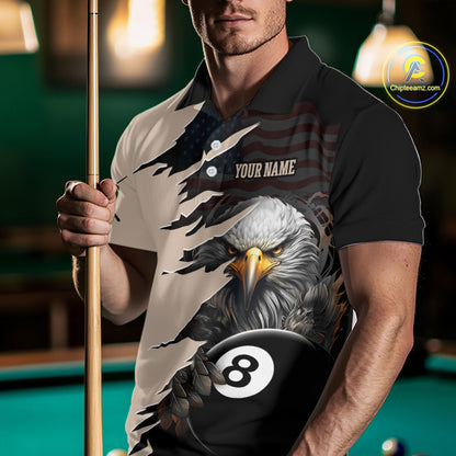 Man wearing a polo shirt with an eagle and pool ball design, holding a pool cue in a billiards setting.