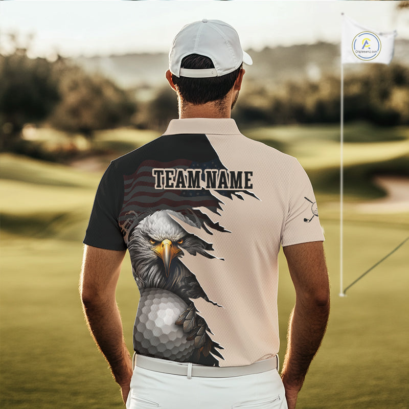 A man wearing a custom golf polo shirt with a bald eagle and golf ball graphic, standing on a golf course. The shirt features a split design with a beige left side and a black right side, with a torn-paper effect revealing a US flag pattern underneath.