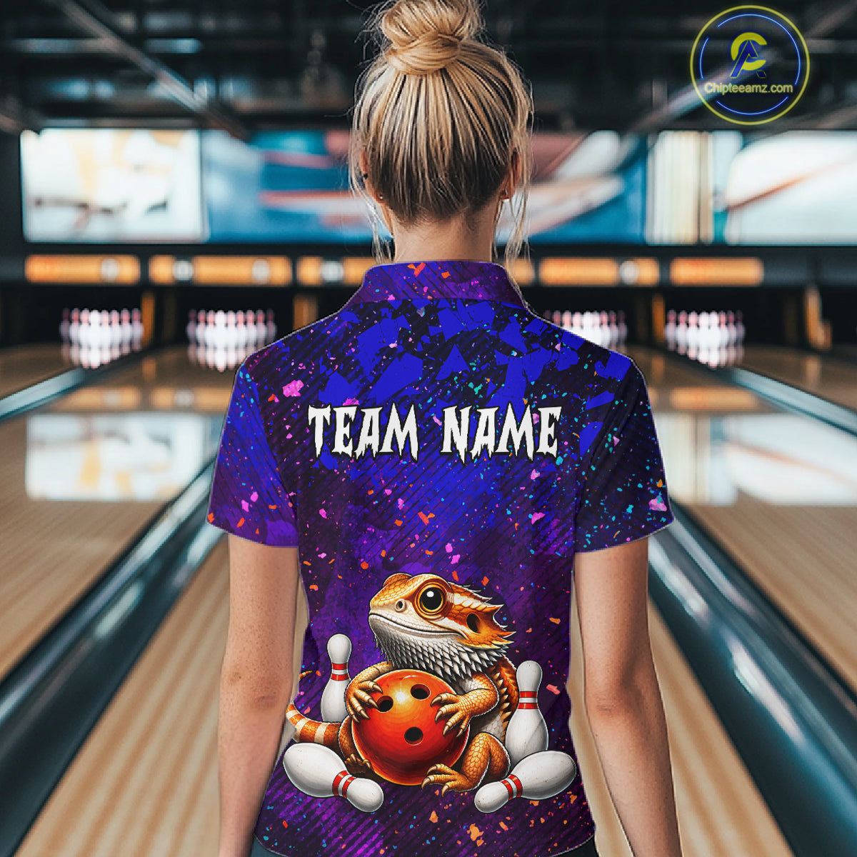 Women’s funny bearded dragon bowling polo shirt, back view on female model in bowling lane 