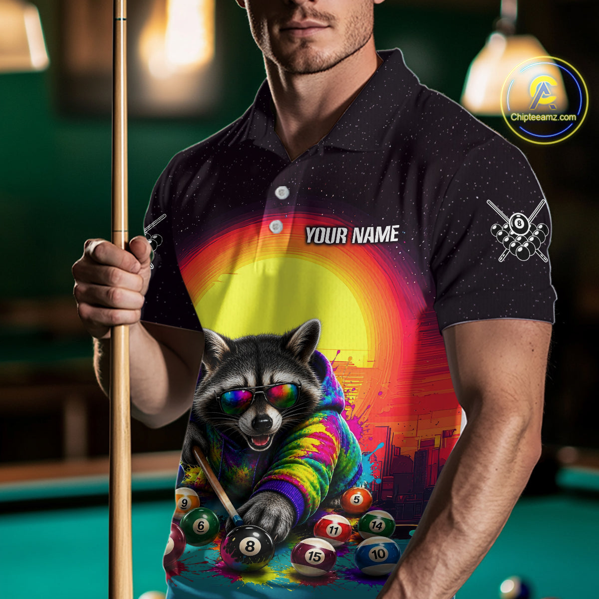 Person wearing a polo shirt with a colorful raccoon design and 'Your Name' text, holding a pool cue on a pool table.