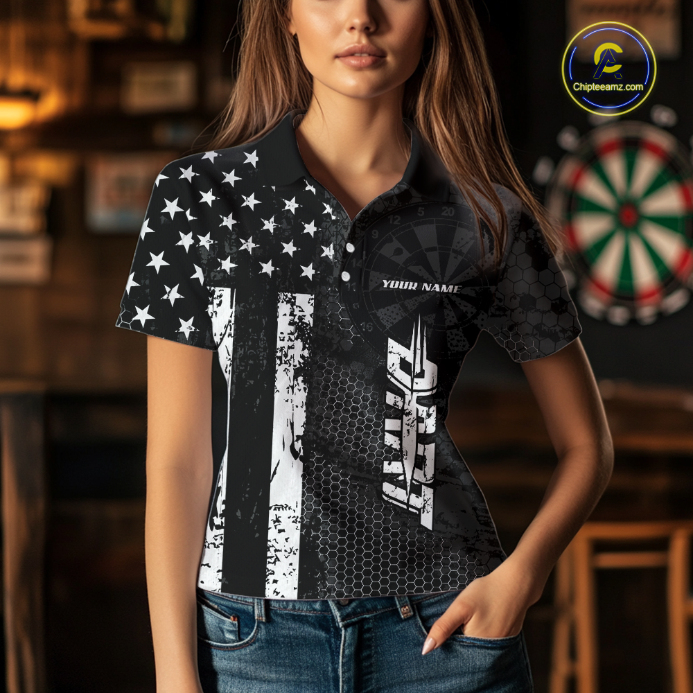Women wearing darts polo shirt featuring dartboard patterns layered with american flag graphics and geometric details on a black background.