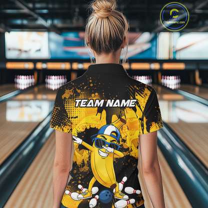 Woman wearing a black and yellow bowling quarter zip featuring a cool banana mascot dabbing, bowling pins, a blue bowling ball, and custom team name text.