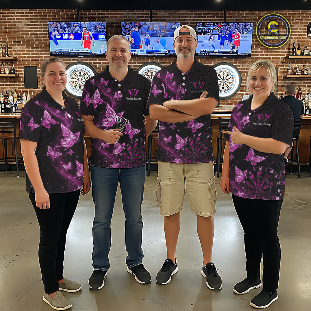 Four people standing together in a bar setting, wearing matching black polo shirts with a purple butterfly pattern. 