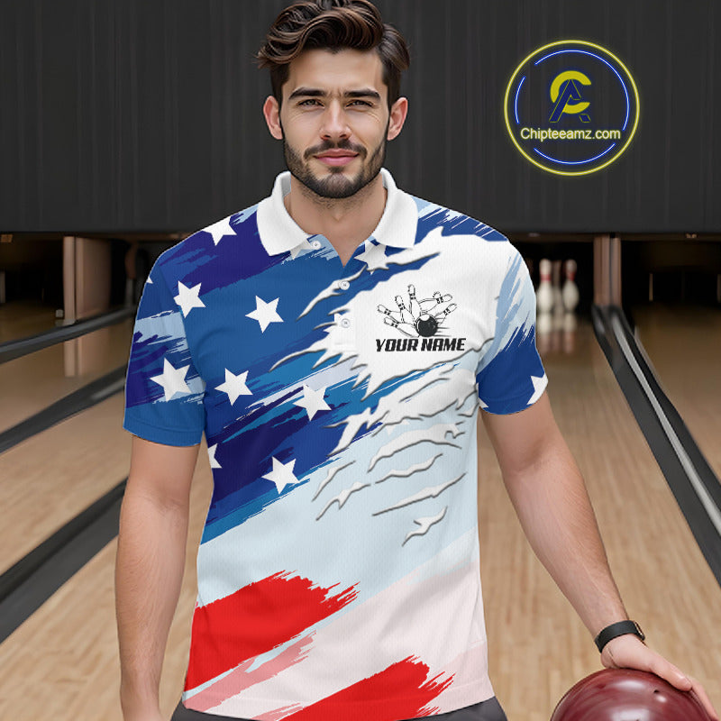 A man in a bowling alley wearing a short-sleeve polo shirt with a distressed American flag design in blue, white, and red. The shirt features a white collar, a black bowling graphic with 'YOUR NAME' text on the chest.
