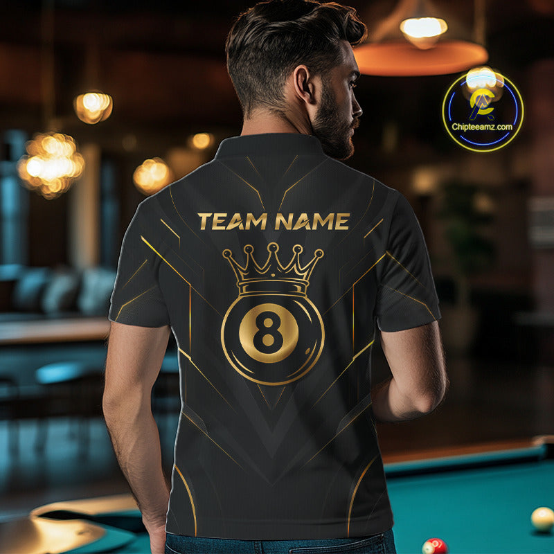 Man wearing a black and gold polo shirt with 'Team Name' and a crown design in a pool hall.