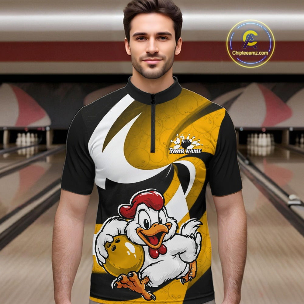 A man wearing a short-sleeve bowling jersey with a black, yellow, and white graphic design featuring a cartoon chicken holding a bowling ball. The background shows blurred bowling lanes, 