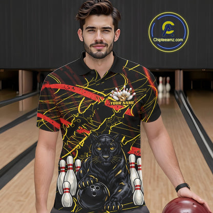 A man wearing a custom bowling-themed short-sleeve polo shirt with a black panther, bowling pins, and red and yellow graphic details, standing in a bowling alley. 