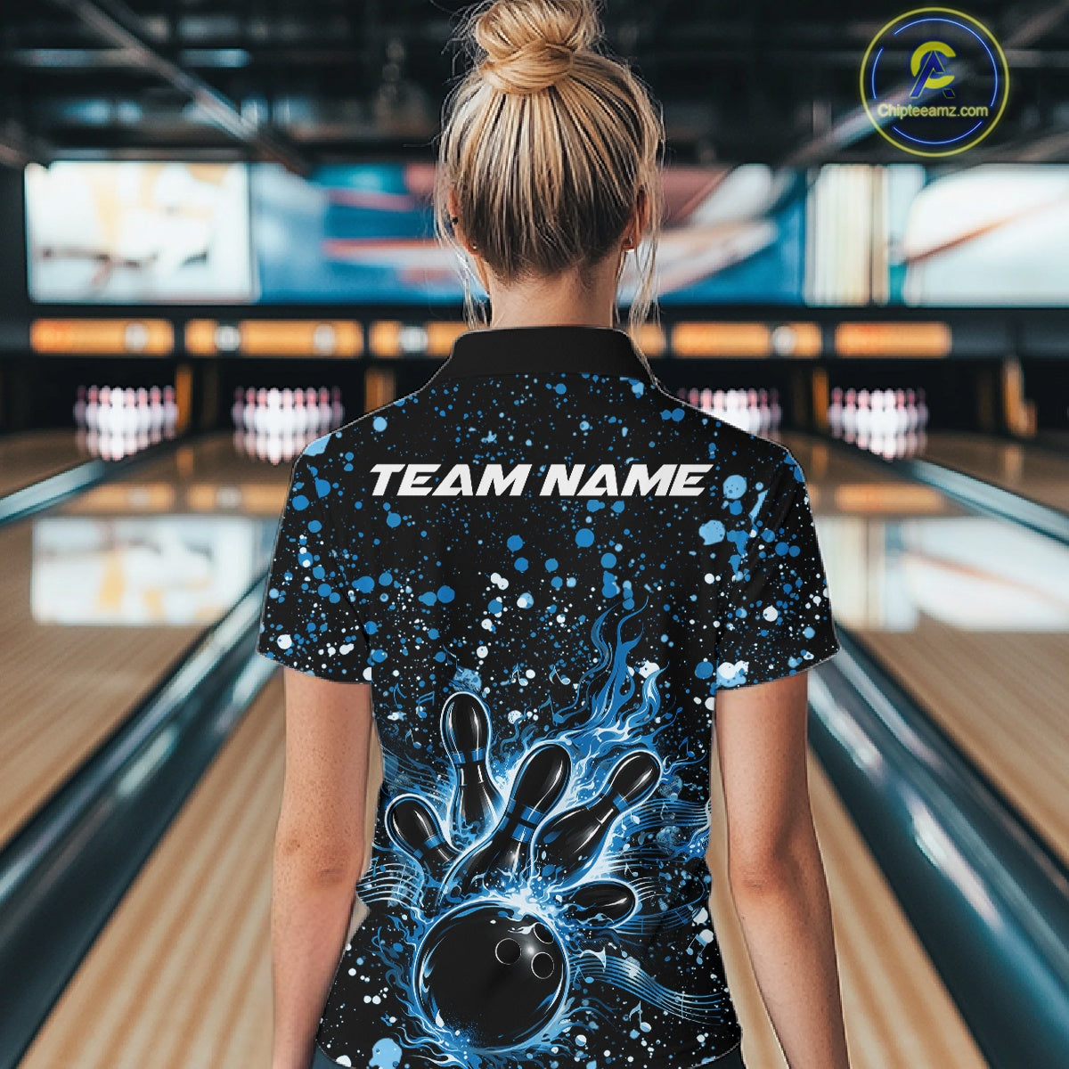 Back view of a female model in a black bowling polo shirt featuring blue paint splatter bowling graphics.