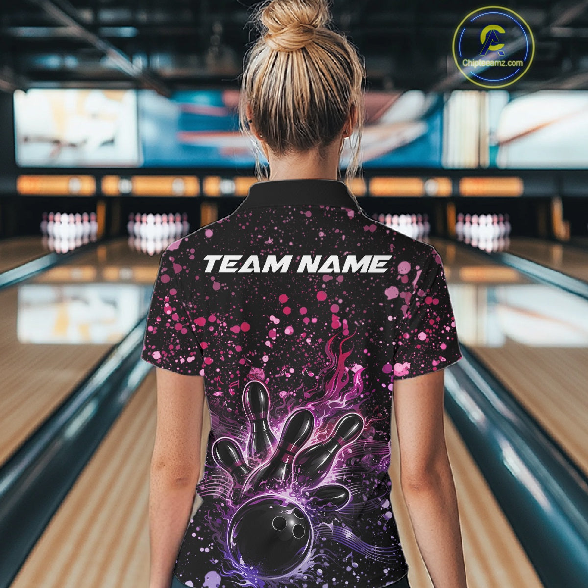 Back view of a female model in a black bowling polo shirt showcasing flaming bowling strike graphics and music-inspired accents.