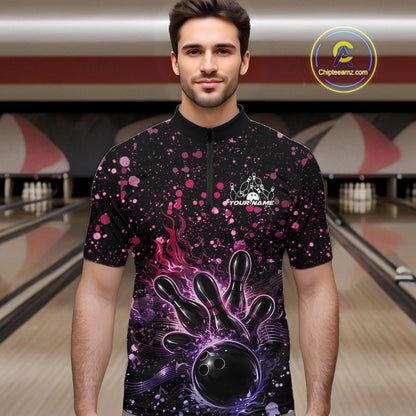 Male model wearing a black bowling quarter-zip shirt at the lane with flaming bowling strike artwork and pink-purple music-themed splatters.