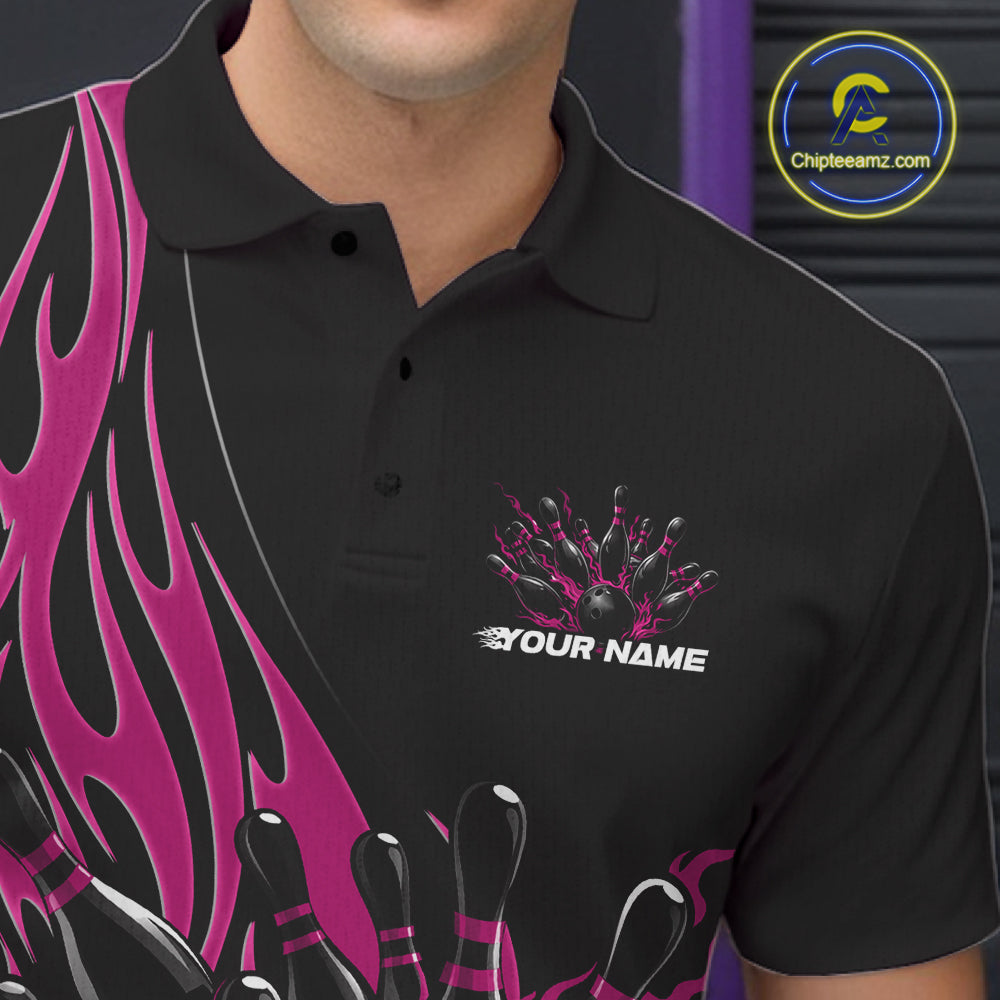 Close-up view of the left chest area of a black polo shirt showing a pink flaming black bowling ball and pins design detail.