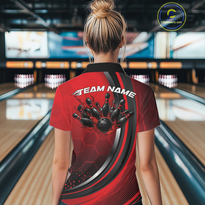 Back view of a female model in a bowling lane wearing a black and red polo shirt, showcasing honeycomb design and flaming bowling ball crashing into pins.