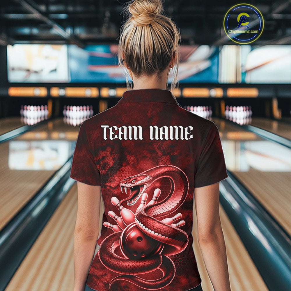 Back view of a womens bowling polo displaying a red cobra wrapped around a bowling ball with scattered pins.