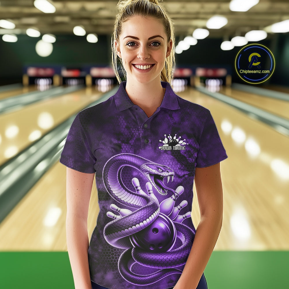 Female model wearing a bowling polo in a bowling lane with purple cobra artwork wrapped around a bowling ball.