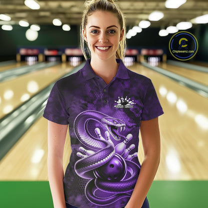 Female model wearing a bowling polo in a bowling lane with purple cobra artwork wrapped around a bowling ball.