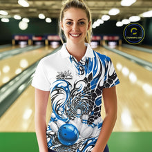 Load image into Gallery viewer, Front view of a female model wearing a white bowling polo with blue and black tribal scale graphics and a glossy red bowling ball hitting the pins