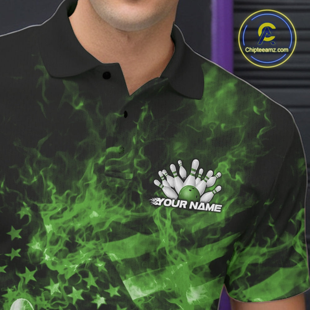 Close-up left chest detail of a black and green bowling polo featuring a flaming bowling ball and patriotic pin artwork.